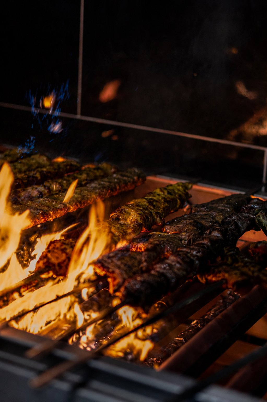Lamb and chicken kebabs cooking over the open flame grill at Reyhan Persian & Turkish Cuisine in Weston ACT